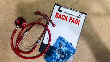 Concept of Back Pain write on paperwork isolated on Wooden Table.