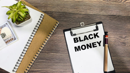 Concept of Black Money write on paperwork isolated on Wooden Table.の写真素材