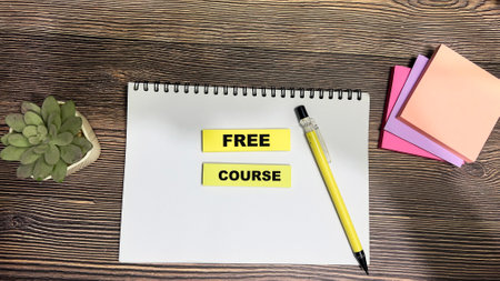 Concept of Free Course write on sticky notes isolated on Wooden Table.の写真素材
