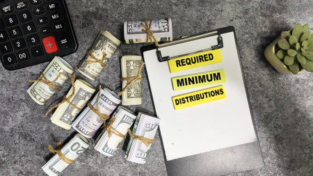 Concept of Required Minimum Distributions write on sticky notes isolated on Wooden Table.