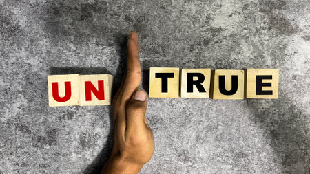Concept of The wooden Cubes with the word untrue or true on wooden background.の写真素材