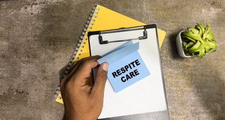 Concept of Respite Care write on sticky notes isolated on Wooden Table.