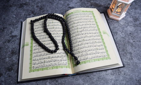 The holy quran, prayer beads, golden ramadhan lamp with islamic rosary beads on dark background ramadhan. Islamic conceptの写真素材