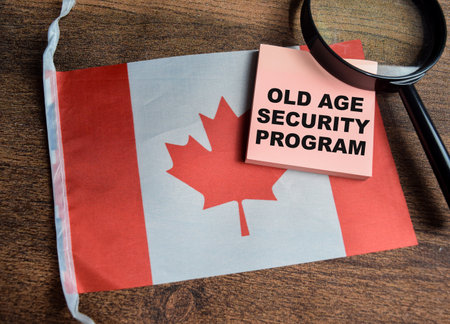 Concept of Old age Security program write on sticky notes and canada flag isolated on Wooden Table.の写真素材