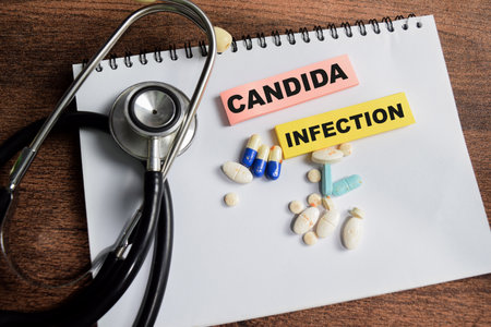 Concept of Candida Infection write on sticky notes isolated on Wooden Table.の写真素材