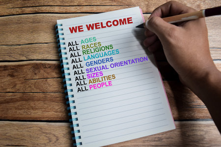 Concept of We Welcome write on book with keywords isolated on Wooden Table.の写真素材