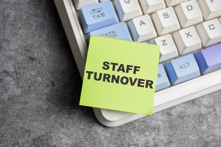 Concept of Staff turnover write on sticky notes isolated on Wooden Table.の写真素材