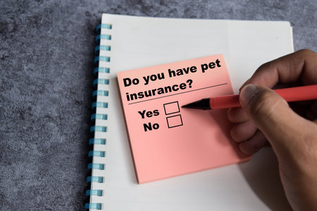 Concept of Do you have pet insurance yes or no write on sticky notes isolated on Wooden Table.の写真素材