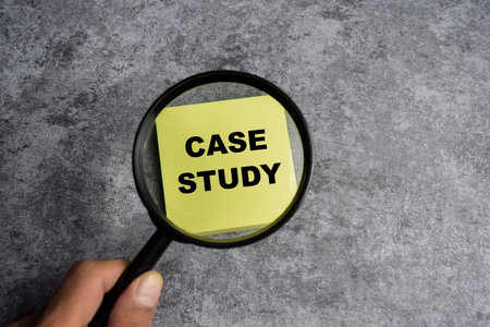 Concept of Case study with magnifying glass write on sticky notes isolated on Wooden Table.の写真素材