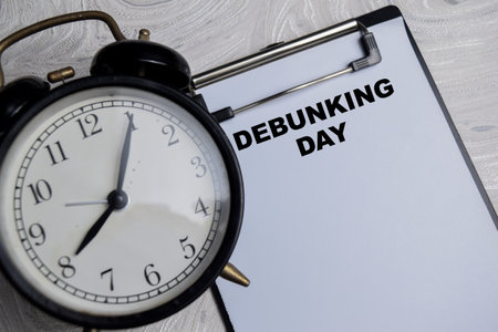 Concept of Debunking Day write on paperwork isolated on Wooden Table.の写真素材