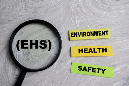 Concept of EHS - Environment Health Safety write on sticky notes isolated on Wooden Table.の写真素材
