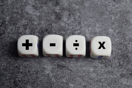 Basic mathematical operation symbols. Plus, minus, multiply and divide symbols on wooden cubes or dice. Basic calculate for business conceptの写真素材