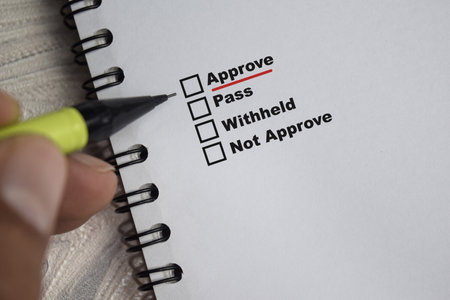 Concept of pointing Approve and underlined in red color write on paperwork isolated on Wooden Table.