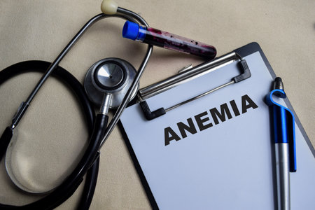 Concept of Anemia write on clipboard isolated on Wooden Table. stethoscopeの写真素材
