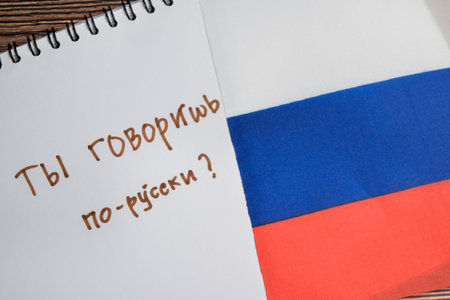 Concept of with question do you speak russian write on book and flag isolated on Wooden Table.の写真素材