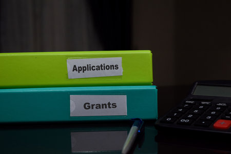 folders with the label Applications and grants. Business management concept