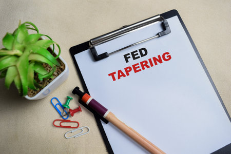 Concept of tapering write on clipboard isolated on Wooden Table.の写真素材