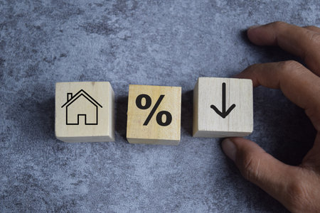 Concept of house, percent and down arrow Symbol. Wooden block with words house, percent and down arrowの写真素材