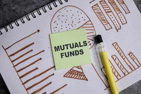Concept of Mutuals funds write on sticky notes isolated on Wooden Table. stock and chart business conceptの写真素材
