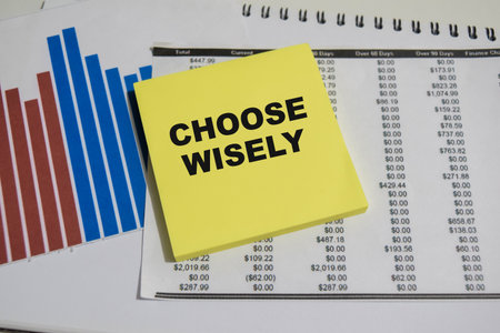 Concept of Choose wisely write on sticky notes isolated on Wooden Table.
