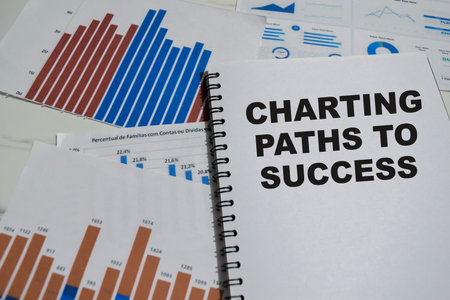 Concept of Charting paths to success write on book isolated on Wooden Table.の写真素材