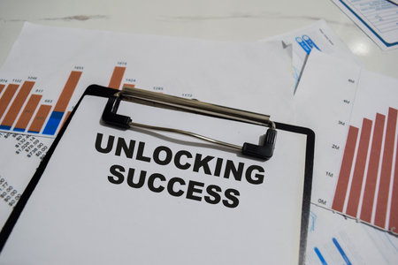Concept of Unlocking Success write on paperwork isolated on Wooden Table.の写真素材