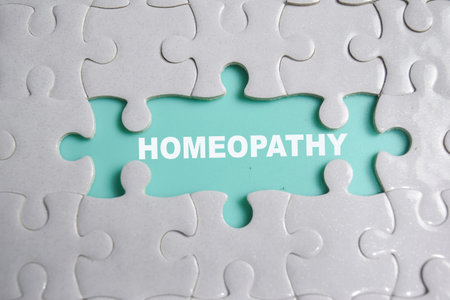 Piece of jigsaw puzzle and word homeopathy.の写真素材