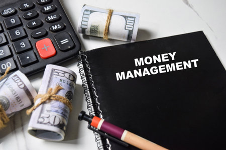 Concept of Money Management write on book isolated on Wooden Table.の写真素材
