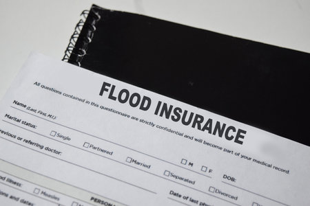 Concept of Flood insurance write on form isolated on Wooden Table.の写真素材