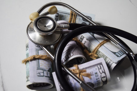 Stethoscope and dollar currency on white table. healthcare or Medical conceptの写真素材