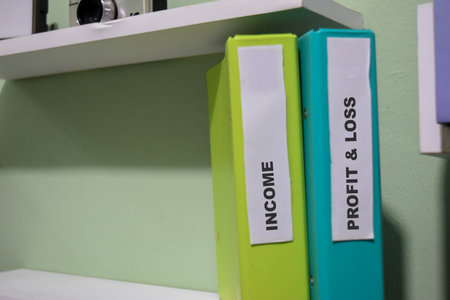 Folders with the label income and Profit - loss. Business management conceptの写真素材