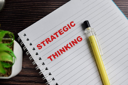 Concept of strategic thinking write on book isolated on Wooden Table.