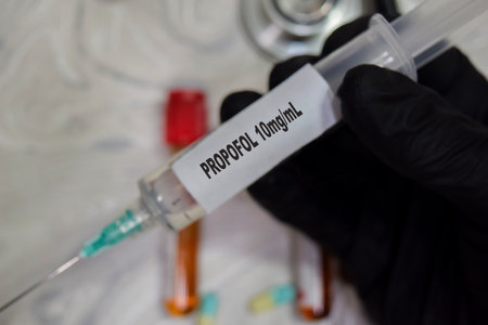 Propofol 10ml vaccination drug syringe in black gloved hands. Medical concept