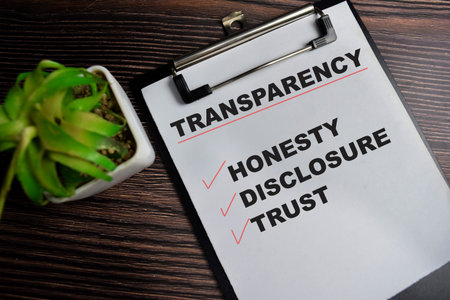 Concept of Transparency write on clipboard with keywords isolated on Wooden Table.の写真素材