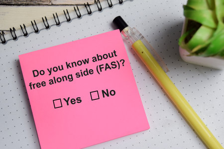 Do you know about free along side - FAS write on sticky notes isolated on Wooden Table. A person is answering question conceptの写真素材