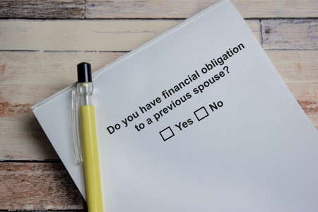 Do you have financial obligation to a previous spouse write on book isolated on Wooden Table. A...