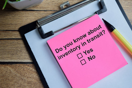 Do you know about inventory in transit write on sticky notes isolated on Wooden Table. A person is...