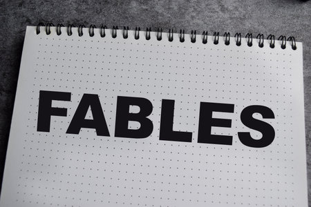 Concept of Fables write on book isolated on Wooden Table.