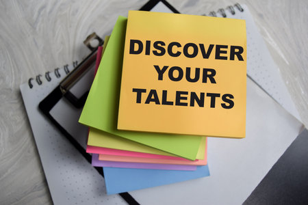 Concept of discover your talent write on sticky notes isolated on Wooden Table.の写真素材