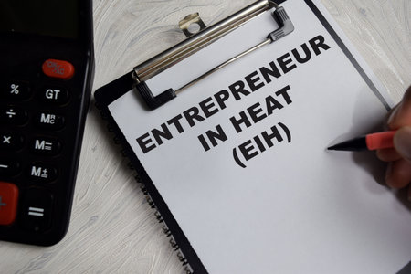 Concept of Entrepreneur in heat write on clipboard isolated on Wooden Table.の写真素材
