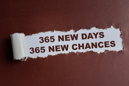 365 New days 365 new chances Text written in torn paper