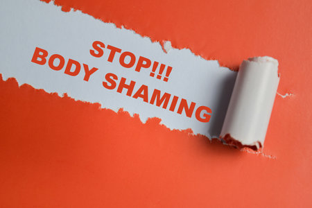 Stop!! body shaming Text written in torn paperの写真素材