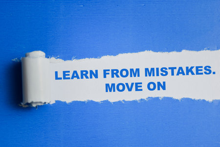 Learn from mistakes. Move on Text written in torn paper
