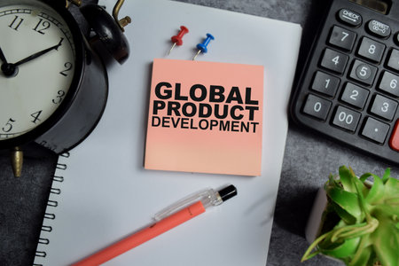 Concept of Global product development write on sticky notes isolated on Wooden Table.