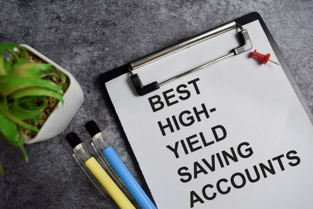 Concept of Best high yield saving account write on clipboard isolated on Wooden Table.の写真素材