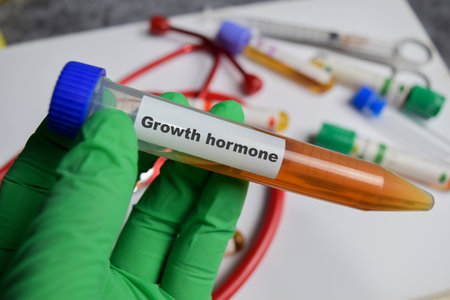 Growth hormone vaccination drug in green gloved hands. Medical conceptの写真素材