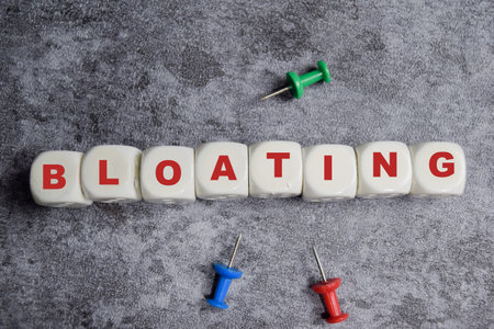 Bloating on stacked wooden cubes on the table. Business and finance conceptの写真素材