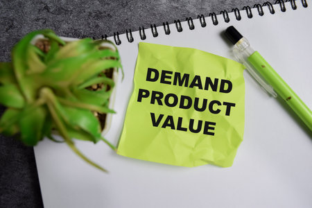 Concept of Demand product value write on sticky notes isolated on Wooden Table.の写真素材