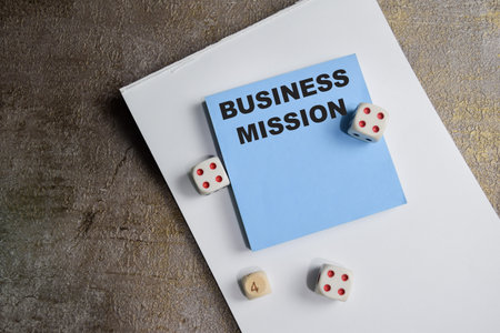 Concept of Business mission write on sticky notes isolated on Wooden Table.の写真素材