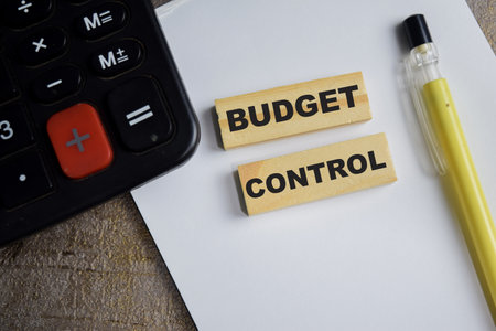 Budget control on stacked wooden cubes on the table. Business and finance conceptの写真素材